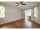 Spacious bedroom featuring wood-look tile floors, ceiling fan, and access to a patio at 6626 Royal Forest Dr, Lakeland, FL 33811