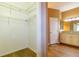 Walk-in closet with wire shelving adjacent to bathroom featuring granite counters at 6626 Royal Forest Dr, Lakeland, FL 33811