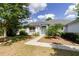 Charming single-story home with mature landscaping, lush lawn, and inviting walkway to front door at 6626 Royal Forest Dr, Lakeland, FL 33811