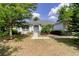 Lovely single-story home with manicured landscaping, mature trees, and a welcoming front entrance at 6626 Royal Forest Dr, Lakeland, FL 33811