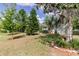Well-maintained single-story home featuring mature trees, a lush lawn and landscaping at 6626 Royal Forest Dr, Lakeland, FL 33811