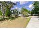 A well-manicured front yard with mature palm trees, lush landscaping, and a charming one-story home at 6626 Royal Forest Dr, Lakeland, FL 33811