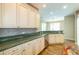 Kitchen with granite countertops, stainless steel appliances, tile backsplash, and hardwood floors at 6626 Royal Forest Dr, Lakeland, FL 33811