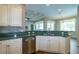 Modern kitchen with stainless steel appliances, granite countertops, tile backsplash, and hardwood floors at 6626 Royal Forest Dr, Lakeland, FL 33811