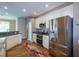 Modern kitchen with stainless steel appliances, granite countertops, white cabinets, and hardwood floors at 6626 Royal Forest Dr, Lakeland, FL 33811