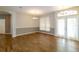 Spacious living room with wood-look floors, elegant lighting, and doors to the outdoor space at 6626 Royal Forest Dr, Lakeland, FL 33811