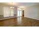 Bright living room featuring wood-look flooring, chandelier lighting, and sliding door access at 6626 Royal Forest Dr, Lakeland, FL 33811