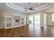 Spacious living area with custom built-ins, ceiling fan, and direct access to the screened patio at 6626 Royal Forest Dr, Lakeland, FL 33811