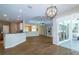 Open-concept living room features hardwood floors, a tray ceiling, and large sliding glass doors leading to a patio at 6626 Royal Forest Dr, Lakeland, FL 33811