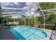 Screened-in pool featuring clear blue water, surrounded by a concrete deck and lush landscaping for privacy at 6626 Royal Forest Dr, Lakeland, FL 33811