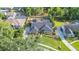 An aerial view of a residence, showcasing a screened-in pool and well-manicured lawn in a tranquil setting at 6911 Wildberry Ln, Lakeland, FL 33813