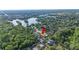 Aerial view of a property nestled within a lush, green residential neighborhood and tree coverage at 6911 Wildberry Ln, Lakeland, FL 33813