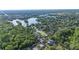 Scenic aerial view of a lakefront community surrounded by mature trees and a mix of single-Gathering homes at 6911 Wildberry Ln, Lakeland, FL 33813