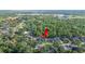 Aerial view of a property nestled within a lush, green residential neighborhood and tree coverage at 6911 Wildberry Ln, Lakeland, FL 33813