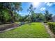 Lush backyard featuring a seating area and mature trees, perfect for enjoying nature at 6911 Wildberry Ln, Lakeland, FL 33813