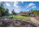 Expansive backyard with a fire pit and well-maintained lawn, perfect for outdoor activities at 6911 Wildberry Ln, Lakeland, FL 33813