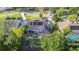 Aerial view of a private backyard featuring a screened-in pool, mature trees and an outdoor living space at 6911 Wildberry Ln, Lakeland, FL 33813
