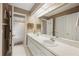 Well-lit bathroom with a double vanity, large mirror, and separate shower at 6911 Wildberry Ln, Lakeland, FL 33813