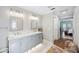 Bright bathroom featuring double vanity, marble floors, and modern fixtures at 6911 Wildberry Ln, Lakeland, FL 33813