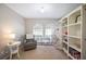 Bright bedroom with arched windows, neutral color palette, and cozy furnishings and a large shelving unit at 6911 Wildberry Ln, Lakeland, FL 33813