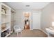 Neutral bedroom with built-in shelves and closet, with a peek into the dining and living area at 6911 Wildberry Ln, Lakeland, FL 33813