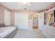 Bedroom with neutral carpet, closet doors, and an ensuite bathroom at 6911 Wildberry Ln, Lakeland, FL 33813
