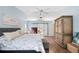 Bedroom with a large decorative armoire, sliding barn doors to the bathroom at 6911 Wildberry Ln, Lakeland, FL 33813