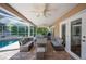 Large covered patio featuring outdoor seating, ceiling fans, and lush yard views at 6911 Wildberry Ln, Lakeland, FL 33813