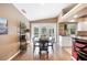 Bright dining area features hardwood floors, views of the pool, and a table with seating for four at 6911 Wildberry Ln, Lakeland, FL 33813