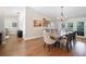 Dining room featuring hardwood floors, chandelier lighting, and a view of the backyard through French doors at 6911 Wildberry Ln, Lakeland, FL 33813