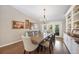 Well-lit dining room featuring hardwood floors, large table, and doors leading to the outdoors at 6911 Wildberry Ln, Lakeland, FL 33813