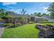 Charming ranch home featuring a well-manicured lawn, mature landscaping, and inviting curb appeal at 6911 Wildberry Ln, Lakeland, FL 33813