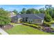 Charming home featuring a well-manicured front lawn and attractive landscaping, enhancing its curb appeal at 6911 Wildberry Ln, Lakeland, FL 33813