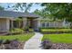 Attractive single-story home showcasing a well-maintained lawn, pathway, and neatly trimmed shrubbery at 6911 Wildberry Ln, Lakeland, FL 33813