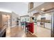 Open kitchen with stainless steel appliances, bar seating, and a view into the dining area at 6911 Wildberry Ln, Lakeland, FL 33813