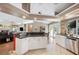 Spacious kitchen with stainless steel appliances, white cabinets, and an eat-in breakfast bar at 6911 Wildberry Ln, Lakeland, FL 33813