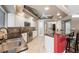 Well-equipped kitchen featuring stainless appliances, white cabinets, and a breakfast bar at 6911 Wildberry Ln, Lakeland, FL 33813