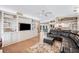 Spacious living room with custom built-ins, a dining area, and a large, comfortable sectional sofa at 6911 Wildberry Ln, Lakeland, FL 33813