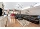 Spacious living room features a ceiling fan, and an oversized sectional sofa atop an area rug at 6911 Wildberry Ln, Lakeland, FL 33813
