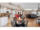 Open-concept space with a dining area, kitchen with bar seating, and a comfortable living room at 6911 Wildberry Ln, Lakeland, FL 33813