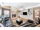 Spacious living room features a fireplace and custom built-ins, with a large sectional sofa at 6911 Wildberry Ln, Lakeland, FL 33813
