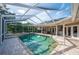 Screened-in pool and patio area complete with outdoor seating and lush landscaping at 6911 Wildberry Ln, Lakeland, FL 33813