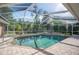 Inviting screened-in pool with a spa and spacious patio, perfect for relaxation and entertaining at 6911 Wildberry Ln, Lakeland, FL 33813