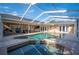 Enclosed pool and patio area featuring a grilling area and comfortable seating at 6911 Wildberry Ln, Lakeland, FL 33813