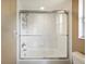 Bathroom shower with glass doors and white tile at 6911 Wildberry Ln, Lakeland, FL 33813
