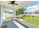 Covered and screened-in porch with great view of backyard and new white privacy fence at 7139 Cedarcrest Blvd, Lakeland, FL 33810
