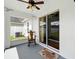Comfortable back porch with rocking chair and view of fenced yard through sliding glass door at 7139 Cedarcrest Blvd, Lakeland, FL 33810