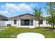 Back of the home with screened-in porch and solar panels installed on the roof at 7139 Cedarcrest Blvd, Lakeland, FL 33810