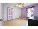 Bedroom features tile floor, lilac accent wall, and closet at 7139 Cedarcrest Blvd, Lakeland, FL 33810