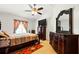 Bedroom features a ceiling fan, dresser, and window with valance at 7139 Cedarcrest Blvd, Lakeland, FL 33810